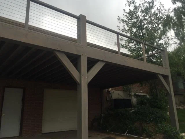 Our timber deck with metal railing supported by large timber posts over the garage and yard