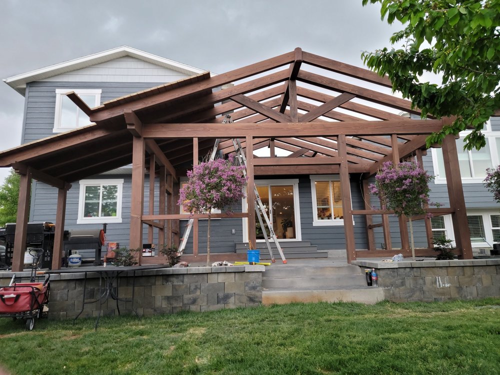 A timber frame pergola, under construction, in the framing stages while being installed