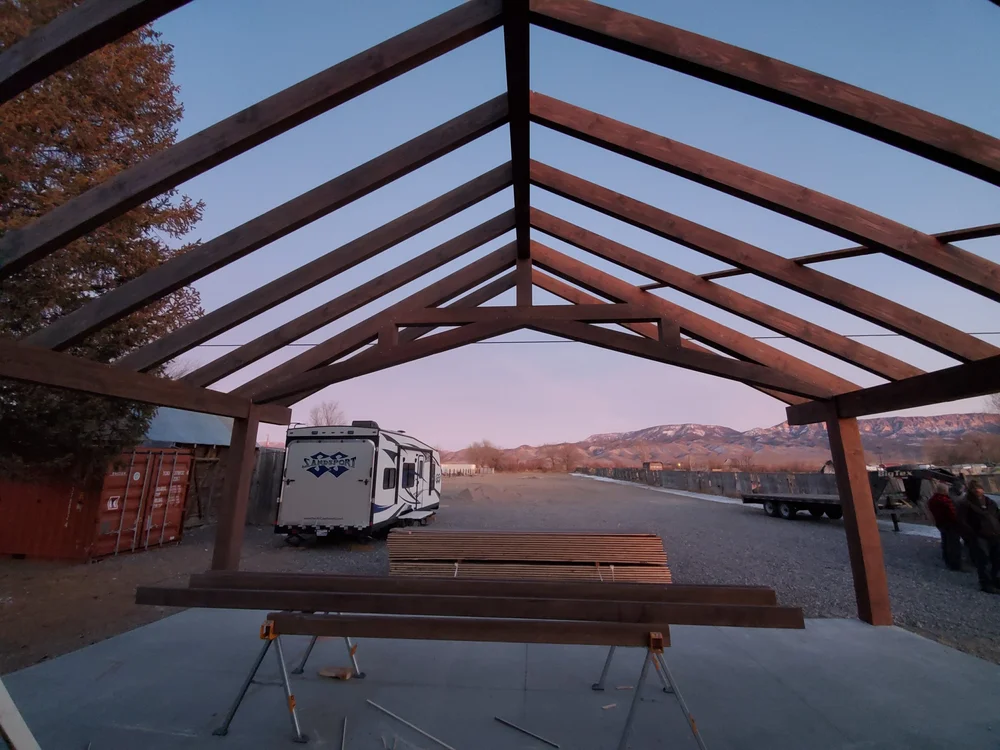 An outdoor scissor pergola being framed at install