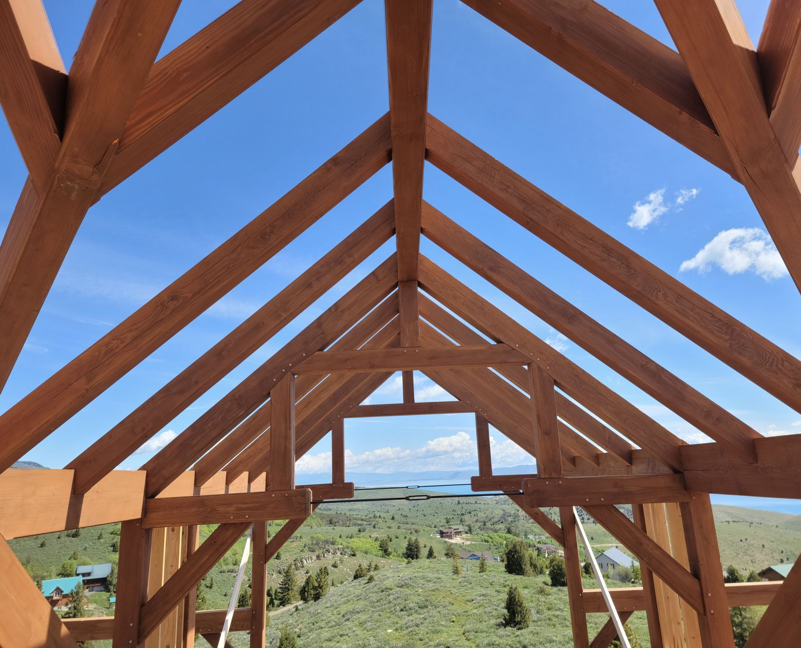 Crew framing timber roof trusses on a client install in Park City