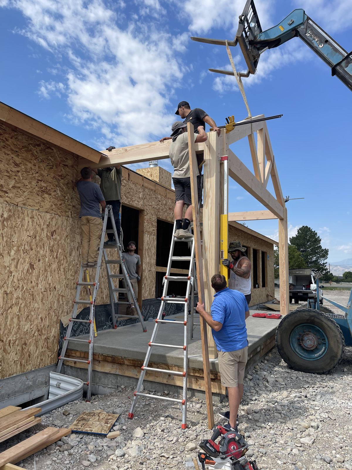 Team building a timber frame porch structure on site