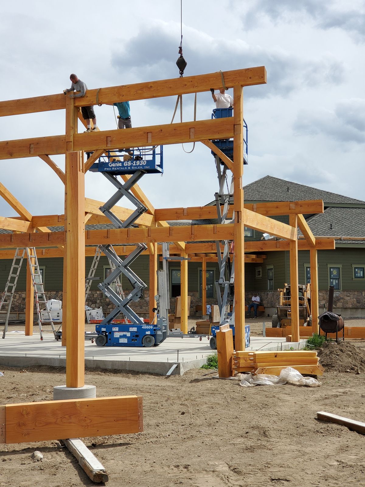 Team installing a heavy timber frame for a custom barn