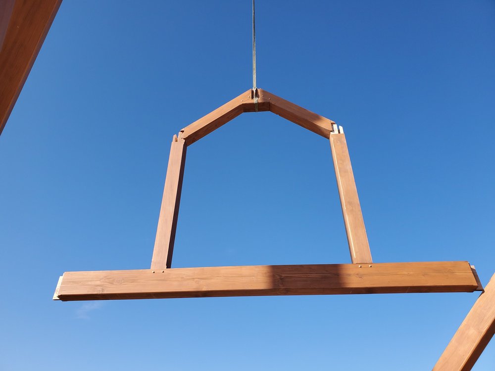 Heavy timber frame being installed on site