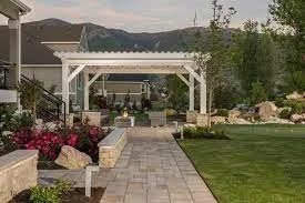 White pergola install over patio with backyard fire pit