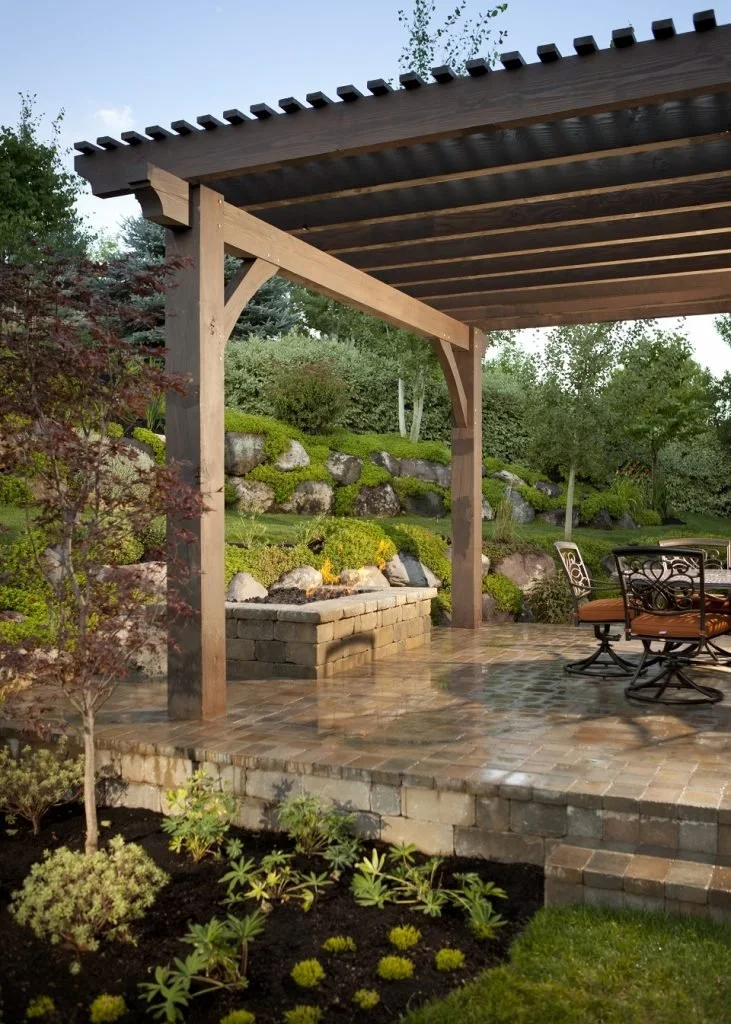 Backyard pergola install overshadowing backyard firepit and patio
