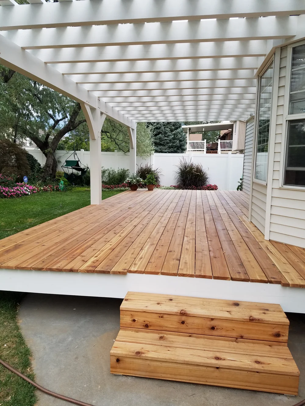 White backyard pergola and patio install for a custom timber design