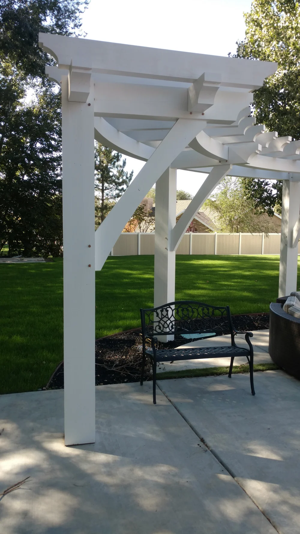 Modern white backyard pergola shading a pool and patio