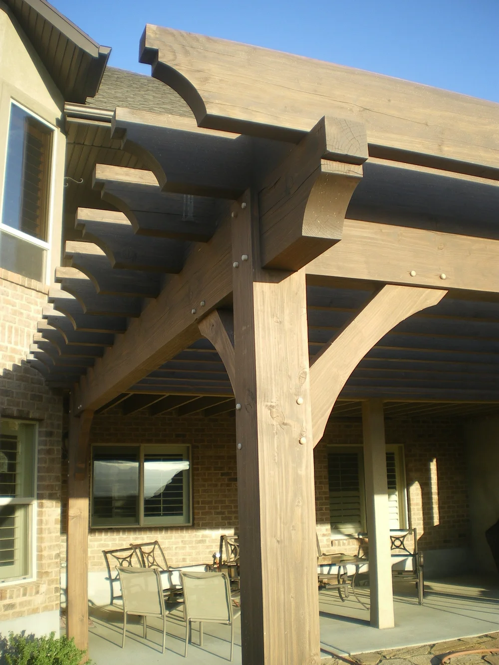 Rustic modern pergola build over a backyard patio