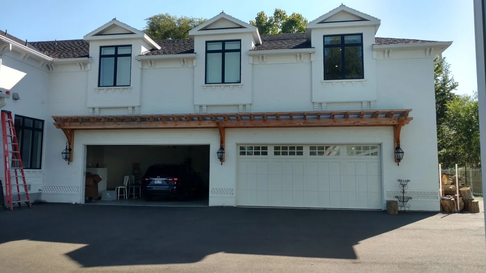 Timber truss installed over a two-car garage entry